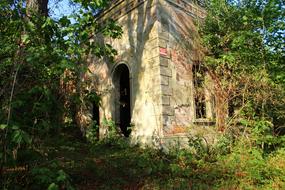 Ruin Of small classic building among greenery