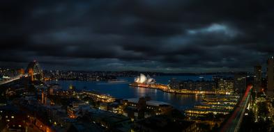 Beautiful panorama of Sydney with the colorful lights, on the shore, in Australia