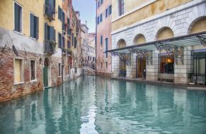 Beautiful, turquoise canal, among the colorful and beautiful buildings in Venice, Italy