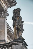 stone statue of a knight on the facade of a building in Poland