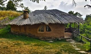 Beautiful clay house, among the colorful plants, at cloudy sky, in Leshten, On Rodopes, Bulgaria