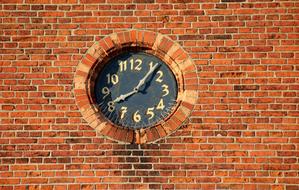 old clock on a brick facade