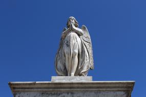 Marble Angel Statue against a bright blue sky