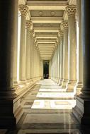 illuminated columnar passage in rome architecture