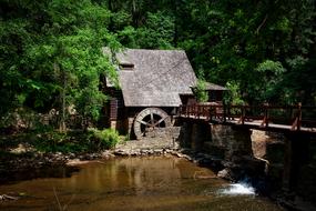 Beautiful mill house near the bridge, among the green plants in Alabama, USA