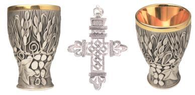 Beautiful and colorful, patterned, shiny cups and cross, at white background