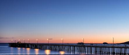 illuminated pier at dusk in california