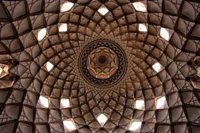 Beautiful, patterned, brown ceiling with the holes, in Iran