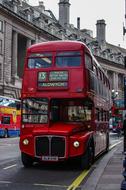 Beautiful, red double-decker bus on the road in London, England, United Kingdom