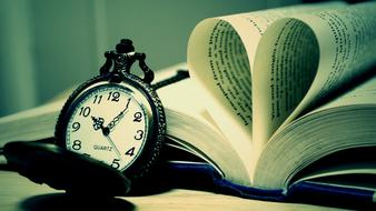 pocket watch and open book