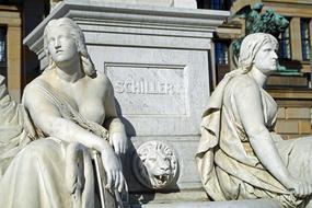 Beautiful monument of Schiller, with the people and decoration, on the street in Berlin, Germany