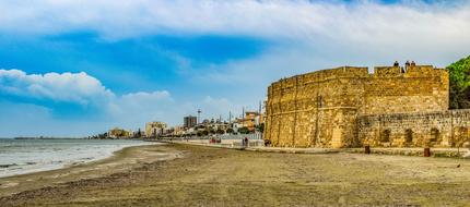 wall of medieval castle on beach at sea, Cyprus, Larnaca