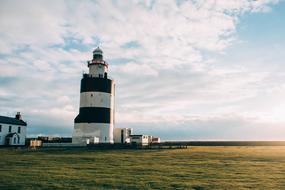 Wonderful lighthouse on the grass on the coast