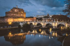 Beautiful Sant'angelo castle with the bridge and colorful lights in Rome, Italy