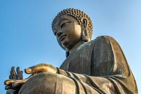 big Buddha Sculpture on blue sky background