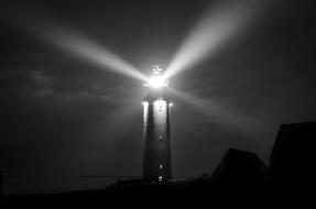 Lighthouse over Sea at Night