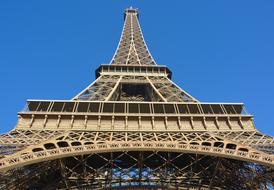 Bottom view of the beautiful Eiffel Tower at blue sky in Paris, France