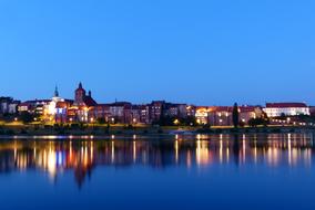 distant view of the palace on the banks of the wisla at dusk