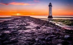 Beautiful landscape with the lighthouse on the shore of New Brighton, at colorful sunset, in England, UK