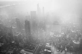 Black and white photo of the beautiful cityscape of New York in fog, in USA