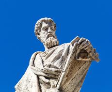 statue in rome against a bright blue sky