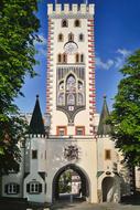 Beautiful and colorful Bayer Gate, among the green trees, in Landsberg Am Lech, Germany