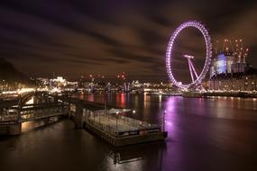 Beautiful landscape of the shore of the river in London, with the bridge, near the London Eye, in the evening