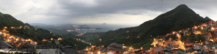 panoramic view of coastal city on hills at dusk, Taiwan