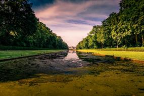 palace and flowering canal in a park in Germany