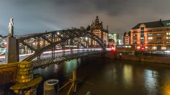 Bridge across channel in old city at night, germany, hamburg, speicherstadt