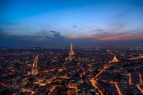 Beautiful Paris city with Eiffel Tower and colorful lights at colorful sunset in France