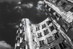 Black and white photo of facades of the buildings on sky backgroud