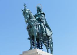 Beautiful, green king statue on the Fishermen's Bastion, at blue sky on background in Budapest, Hungary