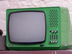 Old, retro, green tv, near the white wall