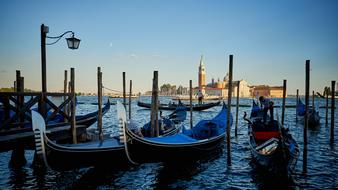 gondolas are moored on a canal in Venice, Italy