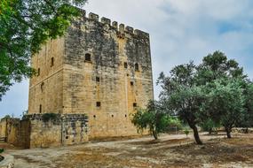 Beautiful, old castle in Kolossi, Cyprus, among the green trees