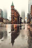 Gooderham Building in front of skyscrapers on misty rainy weather, canada, toronto