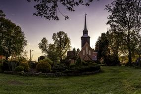 green garden in front of the catholic church