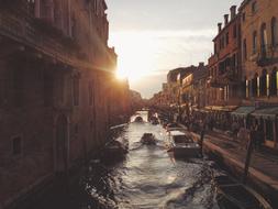 boat and gondola on the canal in venice in the morning