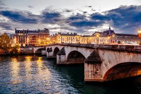 night illumination of the bridge over the river Seine in Paris, France