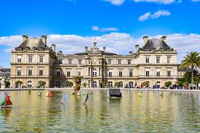 colorful toy boats on pond in front of Luxembourg Palace, France, Paris