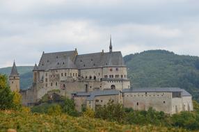 Vianden Castle on forested mountain at autumn, Luxembourg