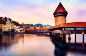 Beautiful landscape of Lucerne, with the bridge and colorful lights, at colorful sunrise in Switzerland