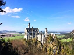 Neuschwanstein Castle, Romanesque Revival palace at top of hill at scenic landscape, Germany, bavaria