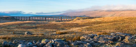 Beautiful Ribblehead Viaduct, among the colorful hills in the Yorkshire Dales in England