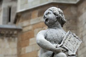child with book, aged stone Sculpture