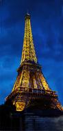 illuminated Eiffel Tower at deep blue sky, France, Paris