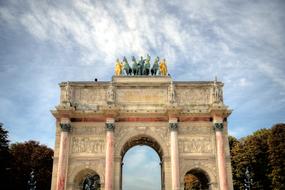 paris arch against the sky with white clouds