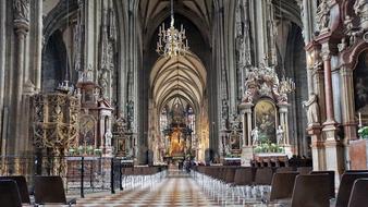 People in the colorful and beautiful St. Stephen's Cathedral with the decorations, in Vienna, Austria