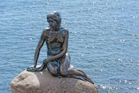 Little Mermaid, bronze statue on stone at water, denmark, Copenhagen